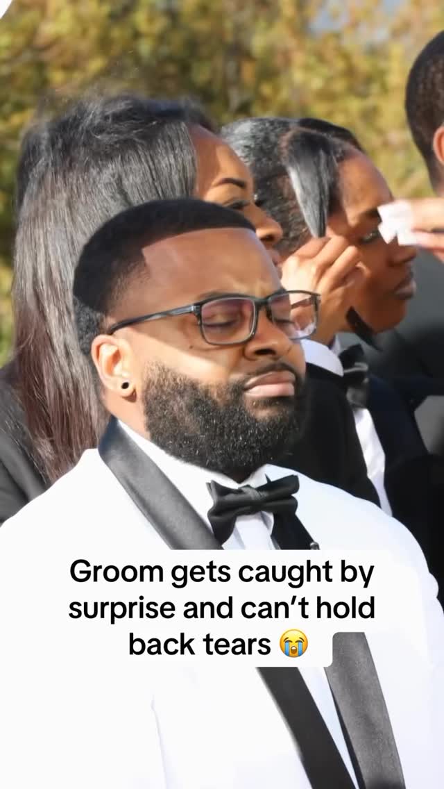 Still from a wedding video — a groom in profile, beginning to react to his bride's voice