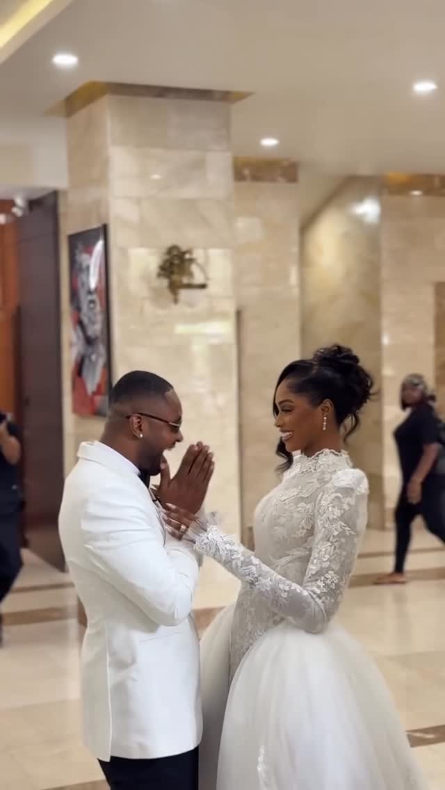 A first-look moment from a Nigerian wedding — the groom seeing the bride before the ceremony, both in soft natural light
